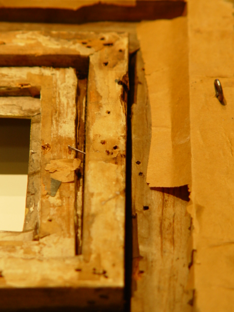 Damage done by insects to the frame and stretcher of an oil painting.